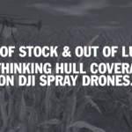 A functioning spray drone sits in a farm field at sunset, with a crashed drone in the foreground, symbolizing the risk of operational downtime.